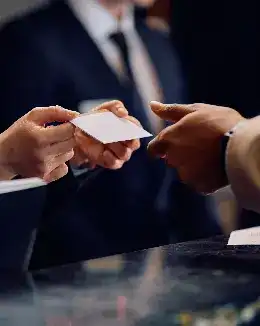 A close up of business partners exchanging their business cards 
