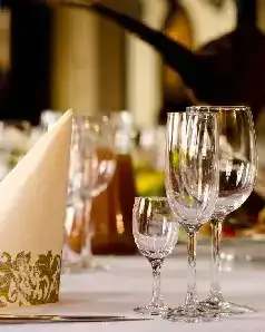 Napkins and wine glasses elegantly arranged on a table at Giza Palace