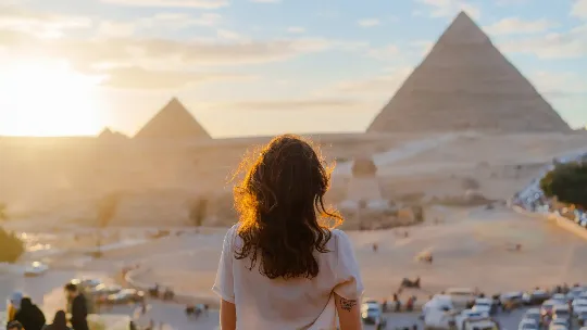 A woman looking at the scenic view of the pyramids in Giza