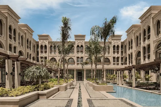 Rendered view of Giza Palace Hotel with a central courtyard featuring a pool & palm trees